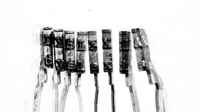 The word Dyslexia with old typewriter hammers stop motion 