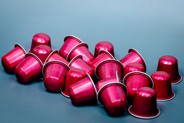Pink Coffee Capsules on Blue Background