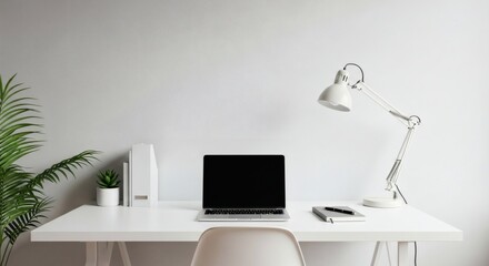 A minimalist workspace featuring a laptop, lamp, plant, and stationery on a white desk against a white wall