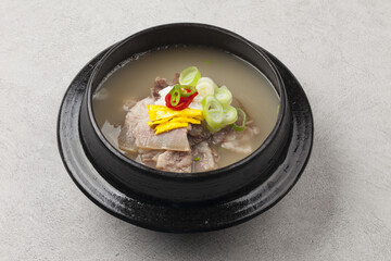  A dish of rice cooked in a soup made with beef head meat, bones, radish, and other vegetables.   
