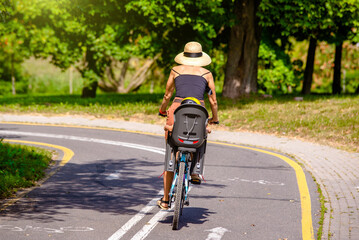 Fototapeta premium Cyclist ride on the bike path in the city Park