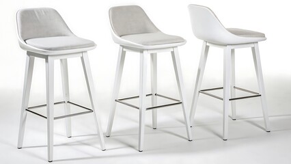 Obraz premium Three modern white bar stools with gray upholstered seats presented against a clean white background in a studio shot