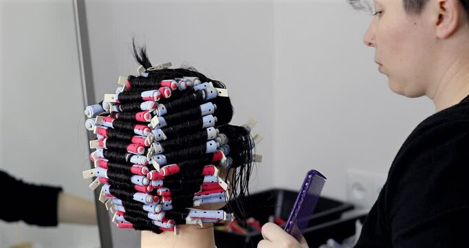 Perm training on a mannequin at the school of hairdressing.