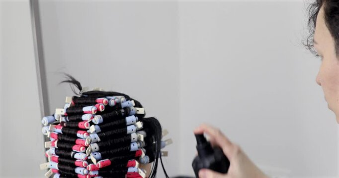 Perm training on a mannequin at the school of hairdressing.