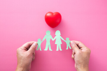 Hand holding a cutting paper of family