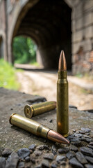 Single bullet on stone surface with dark arch