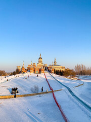 Volga manor, Russian village theme park with classic Russian architecture on a beautiful sunny winter day with a blue-sky, in Harbin, China  © PaBou