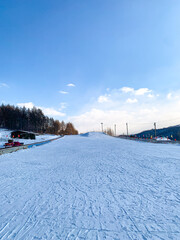 Fototapeta premium Winter and outdoor fun snowy activities, ski, tube slide, snow mobile, banana boat ride at Snow Valley, China 