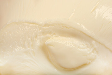A close-up shot reveals the smooth, creamy texture of fresh mozzarella cheese