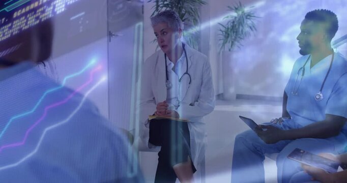 Senior doctor leading case discussion as peer tapping tablet spawning holographic charts for review