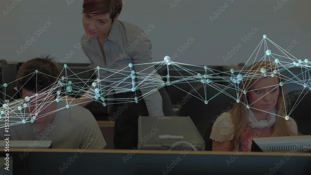 Poster instructor stepping behind students in computer lab, handing pages and guiding screen focus