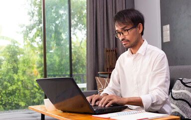 man using laptop with searching job and work from home  
