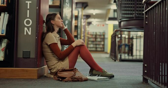 Stress, student burnout and woman in library for test fail, depression and study fatigue in college. University, sad and unhappy girl overwhelmed with assignment deadline, tired and doubt on floor