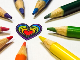 Naklejka premium Rainbow-Colored Pencils Forming a Circle Around a Heart Symbol