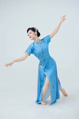 Beautiful dancer performing dance in Chinese cheongsam