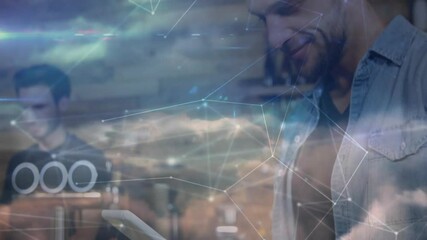 Man tapping tablet in cafe activating network overlay and syncing orders while barista making brew - Powered by Adobe