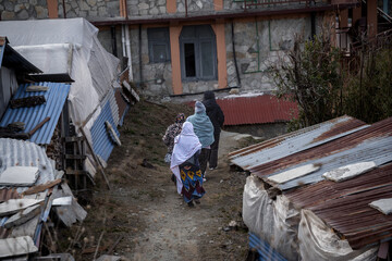 Women looking for a shelter to spend a cold night in the streets of small village Ghorepani in the great Himalaya mountains in Nepal.