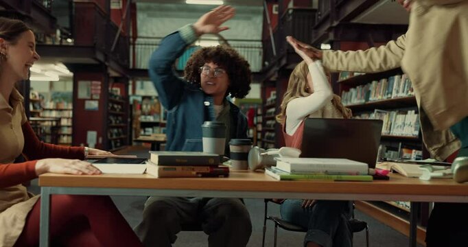 Celebration, high five and group of students in library with good marks, acceptance or scholarship. Happy, textbooks and friends studying together for university exam, test or assignment on campus.
