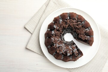 Delicious chocolate bundt cake on light wooden table, top view