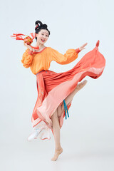 Beautiful dancers wearing ancient Tang Dynasty costumes and makeup performing classical dance