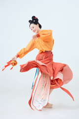 Beautiful dancers wearing ancient Tang Dynasty costumes and makeup performing classical dance