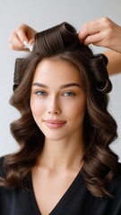 Fototapeta premium Hairstylist Curling a Client's Hair with Professional Technique and Close-up Focus in a Modern Salon Setting