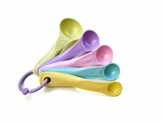 Colourful plastic measuring spoon isolated on white background, high angle view 