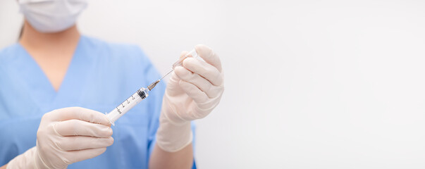 nurse draws medicine from an ampoule into a syringe