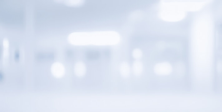 Blurred abstract background of a bright white interior space with lights.