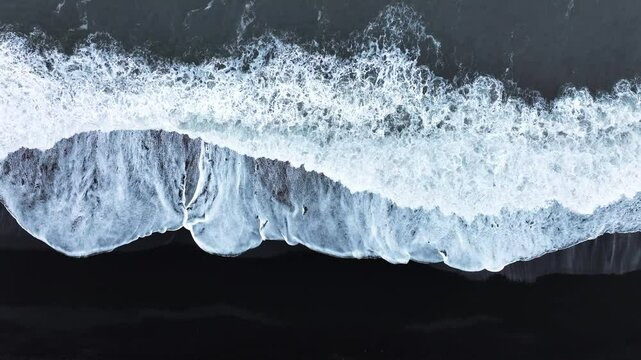 Abstract pattern in nature, Aerial view of black sand volcanic beach with crashing waves