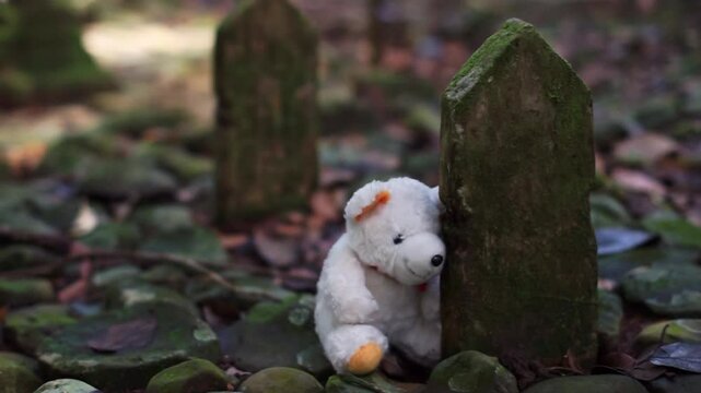 A white teddy bear leaning against a moss-covered gravestone in an old cemetery, symbolizing innocence, grief, and forgotten memories in a quiet, emotional forest setting