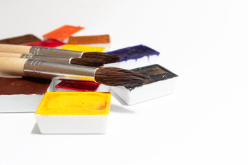 A vibrant color palette of watercolor paints with artist brushes that showcase a variety of shades and textures, perfect for art projects and creative expression
