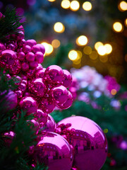 Christmas card with a tree, large pink Christmas balls and bright lanterns