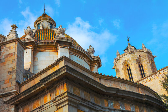 Santa Maria Cathedral in Tarragona, Spain. Detailed view of the cathedral ornate dome and bell tower against a vibrant blue sky