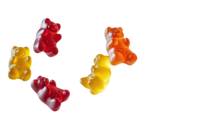Colorful gummy bears scattered on a white background.