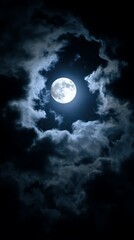 Fototapeta premium Full Moon Shining Through Dark Clouds at Night. A dramatic image of a bright full moon partially obscured by heavy, dark clouds.