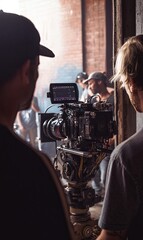 Film crew setting up a camera in an industrial location for shooting