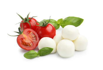 Tasty mozzarella cheese balls, tomatoes and basil isolated on white