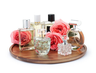 Many different perfume bottles and roses isolated on white