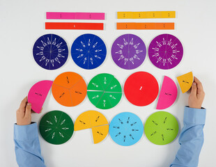 A top-down shot shows hands interacting with a variety of colorful magnetic shapes, including...