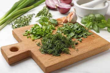 Different herbs and spices on white table, closeup