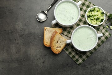 Tasty cucumber soup served on grey table, flat lay. Space for text