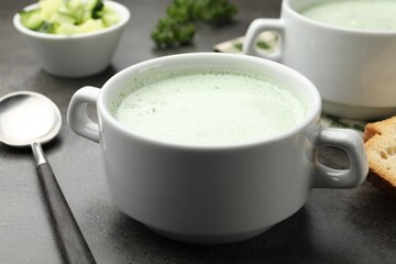 Tasty cucumber soup served on grey table, closeup