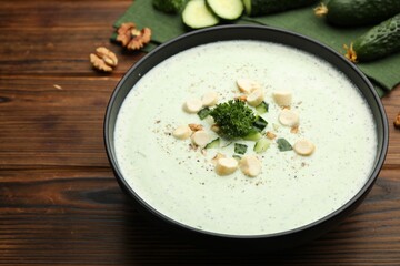 Tasty cucumber soup with croutons and broccoli on wooden table, closeup