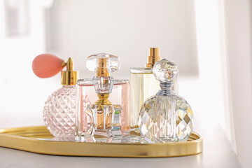Bottles of different perfumes on table indoors, closeup