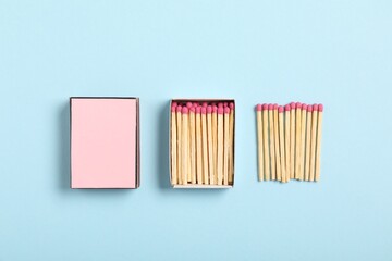 Matches in box on light blue background, flat lay. Mockup for design