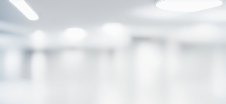 Blurred abstract background of a bright white interior space with lights.