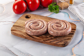 Raw meat pork and beef swirl sausages