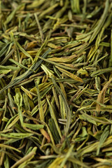 Dried green tea leaves texture background.