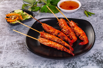 Grilled prawn skewer served sauce